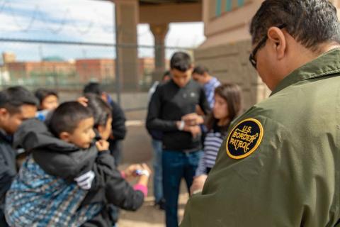 U.S. Border Patrol agent apprehends migrants who surrendered to him after crossing the Rio Grand River in El Paso Texas on March 18, 2019. Credit: U.S. Customs and Border Protection by Mani Albrecht