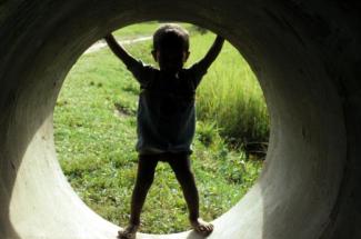 child in tunnel