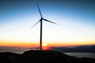 Wind turbine at sunset photo in public domain via unsplash